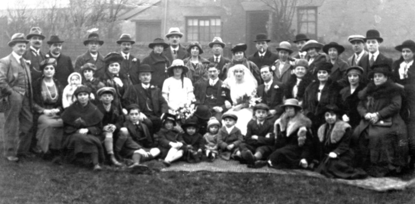 William Henry Hall and Olive Emma Ling's wedding, c. February 1921, Chesterfield, Derbyshire. Olive's mother Mary Ann Bestwick (formerly Ling, formerly Buxton, née Hall) is on the second row, fourth from the right. Courtesy of the National Fairground Archives.