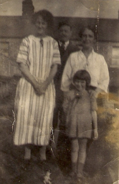 L-R: Aunt Annie Johnson (née Spencer), uncle George Johnson, Julia Mary Mills (in front), aunt Julia Crowe (née Spencer), in front of 47 Ryhall Road, Stamford, 1925.
